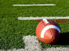 A football lies on an empty field. A football lies on an empty field.