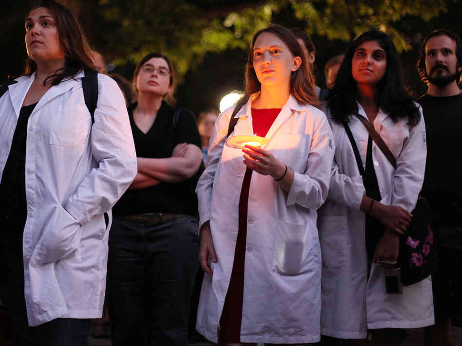 Doctors and other supporters of health care overhaul attend a vigil.