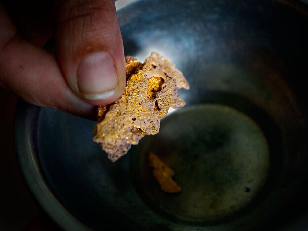 A gold seller in Puerto Maldonado, Peru, offers a piece of pure gold for sale.