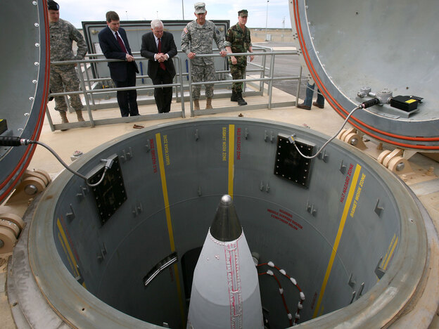 Defense Secretary Robert Gates and others inspect a missile facility.