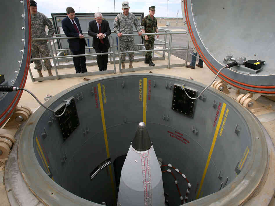 Defense Secretary Robert Gates and others inspect a missile facility.
