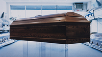 A coffin on display in a showroom.