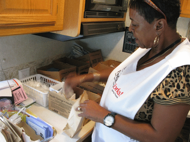 Volunteer Hazel Smith puts together kits of fresh needles.