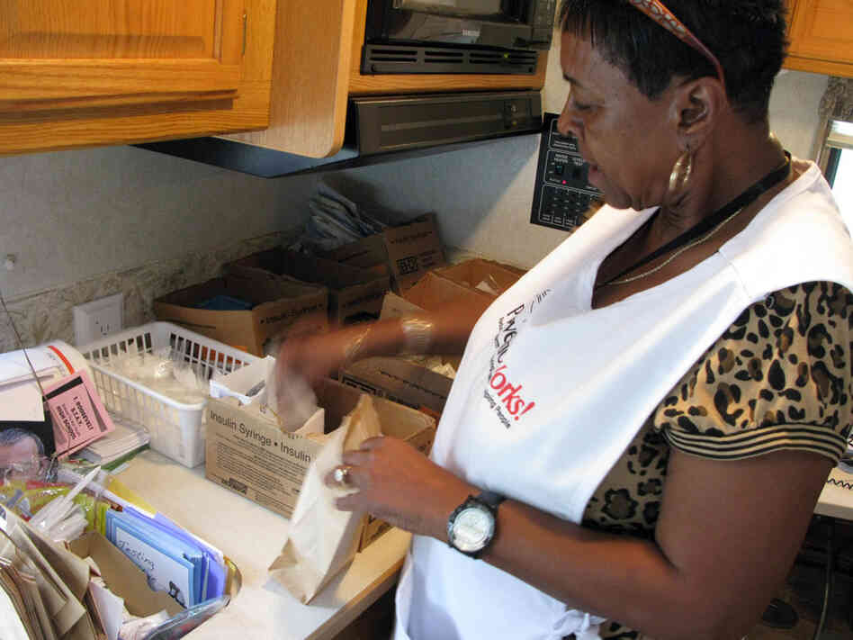 Volunteer Hazel Smith puts together kits of fresh needles.