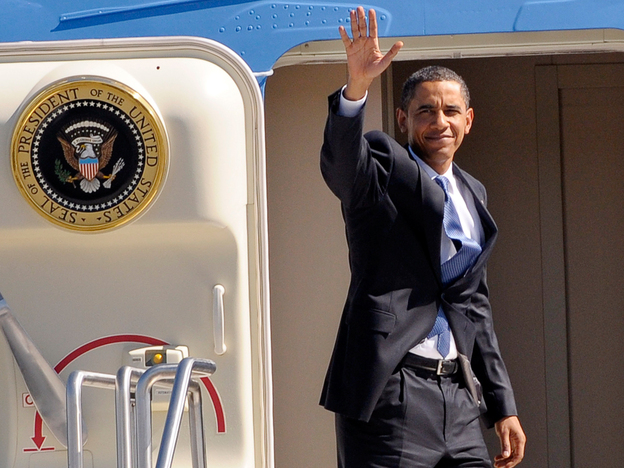 President Barack Obama waves from the doorway of Air Force One.