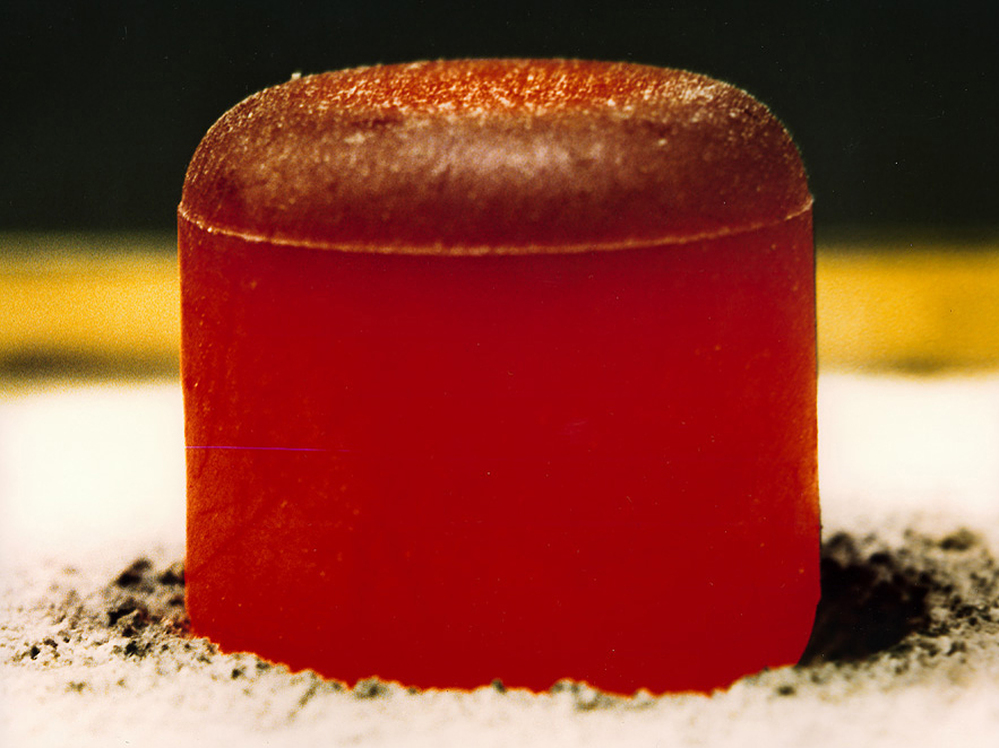 A pellet of plutonium-238 dioxide, glowing red.