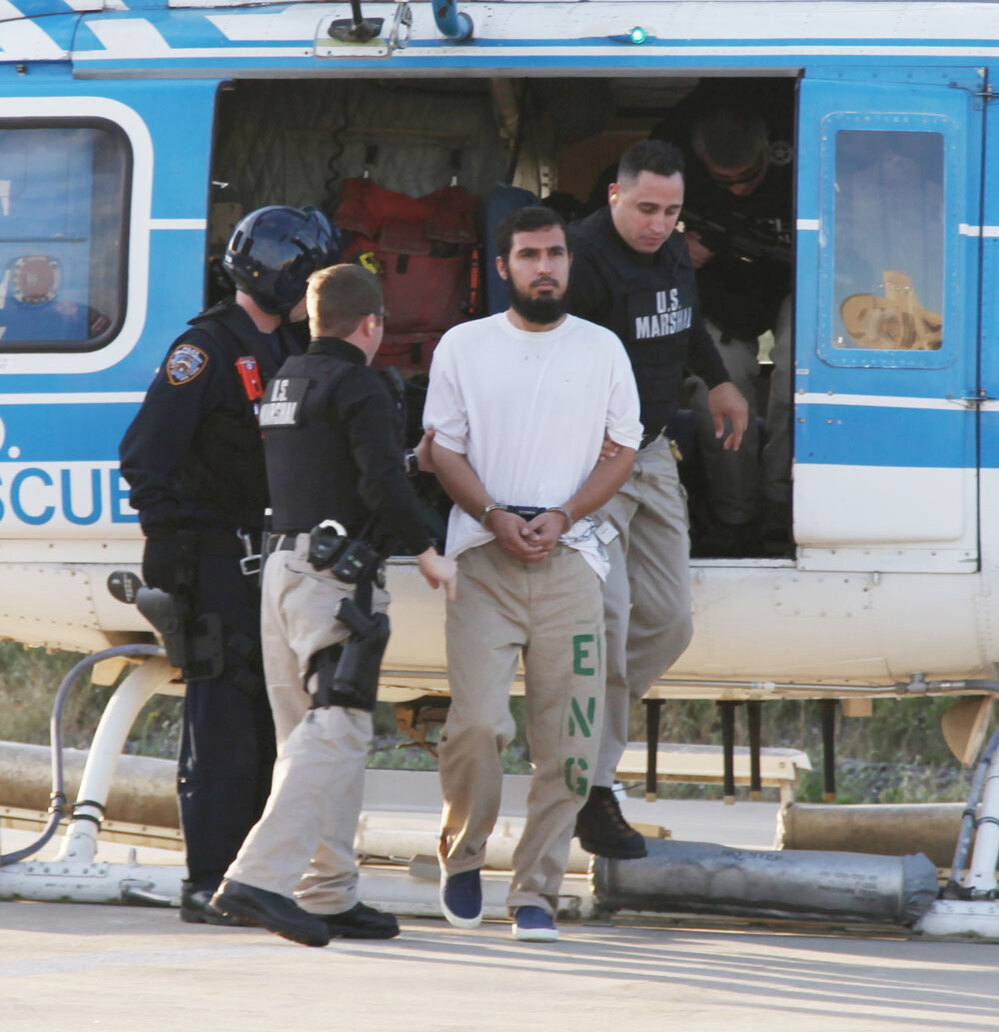 Najibullah Zazi is escorted off a New York Police Department helicopter by U.S marshals
