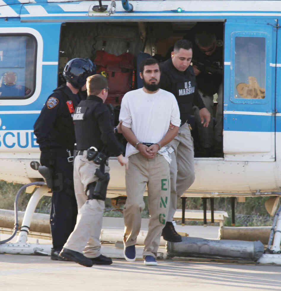 Najibullah Zazi is escorted off a New York Police Department helicopter by U.S marshals