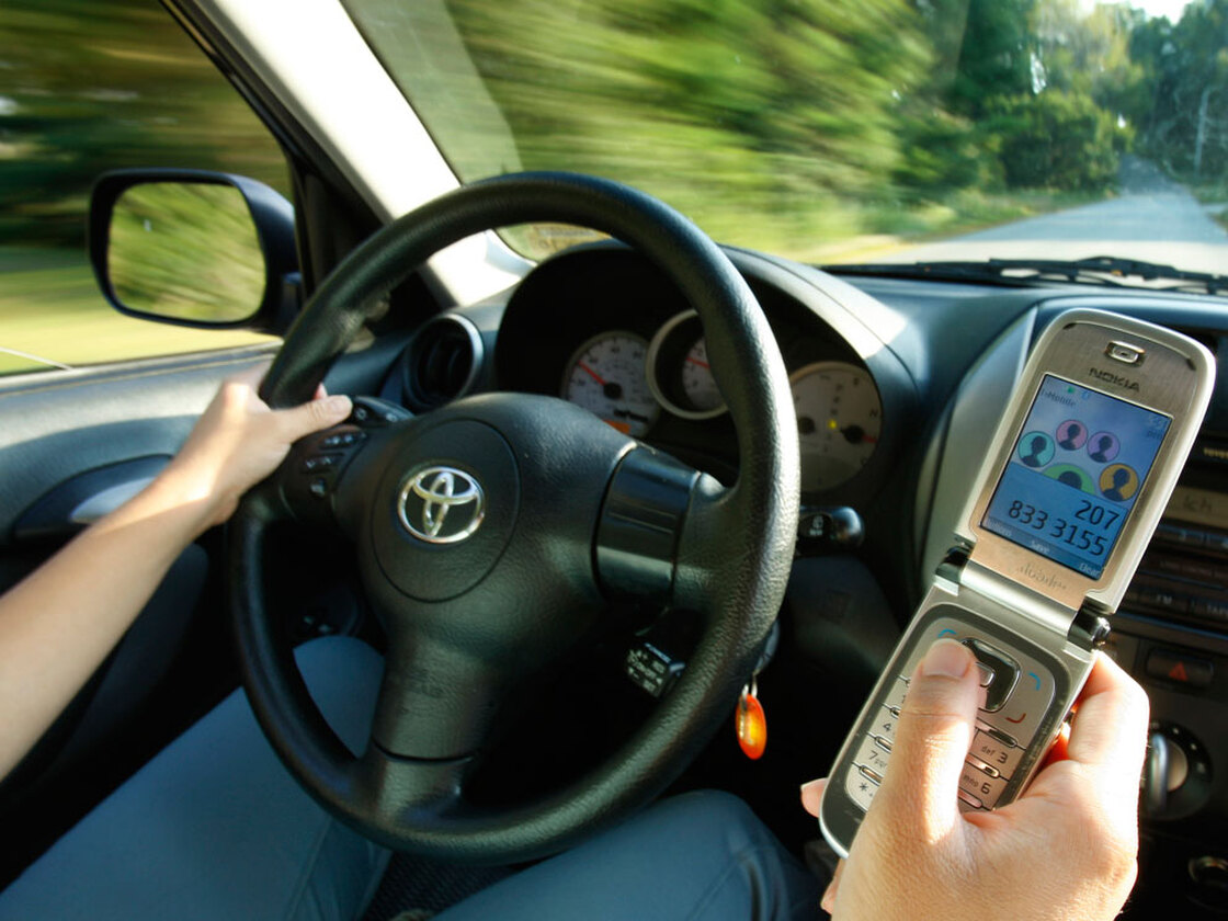 A driver uses a cell phone in Freeport, Maine