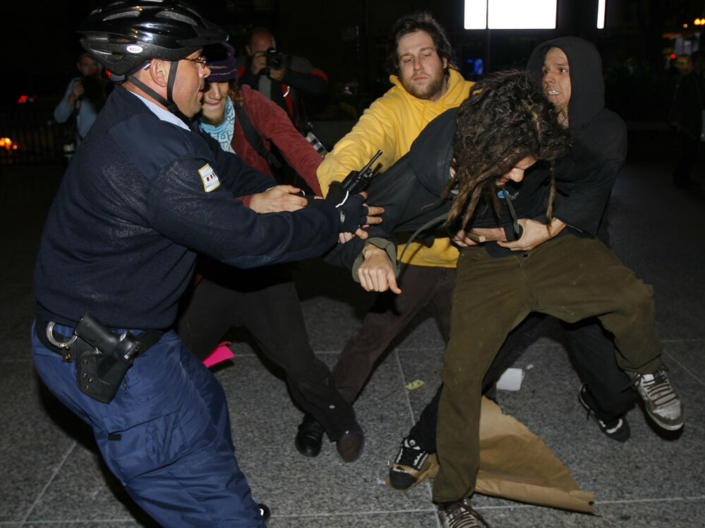 A Chicago police officer scuffles with opponents of Chicago's bid for the 2016 Olympics