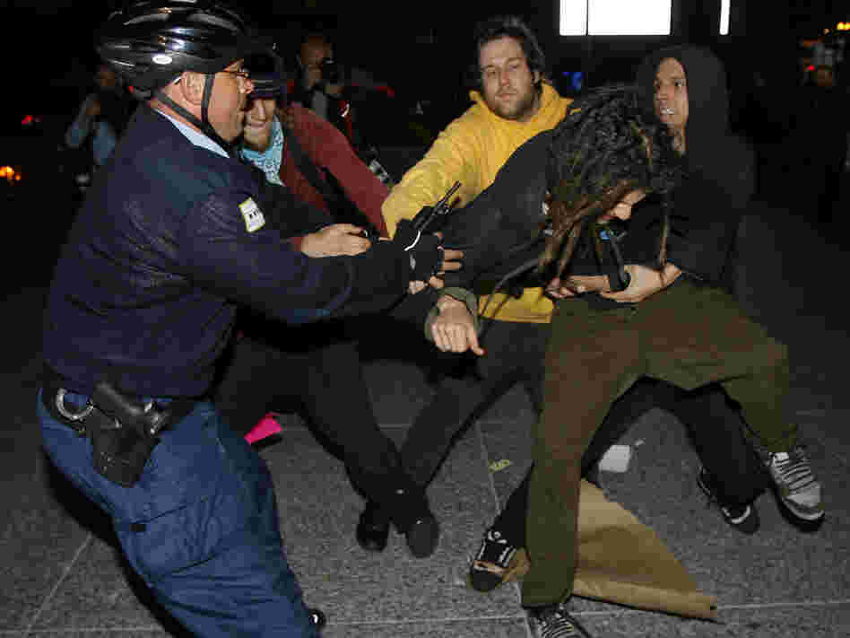 A Chicago police officer scuffles with opponents of Chicago's bid for the 2016 Olympics
