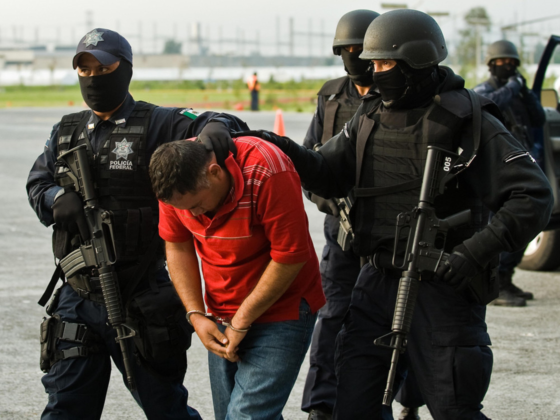 Miguel Angel Beraza Villa, accused of being a drug trafficker, is escorted by police.