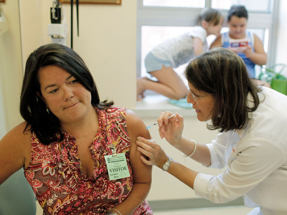 Julie Halverson receives a trial swine flu vaccine.