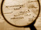 A magnifying glass highlights Afghanistan and Pakistan. A magnifying glass highlights Afghanistan and Pakistan.