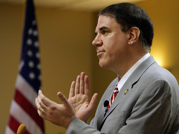 Rep. Alan Grayson (D-FL) leads a round of applause at a town hall meeting in Tavares, Fla.