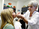 A health care worker receives the swine flu vaccine. A health care worker receives the swine flu vaccine.