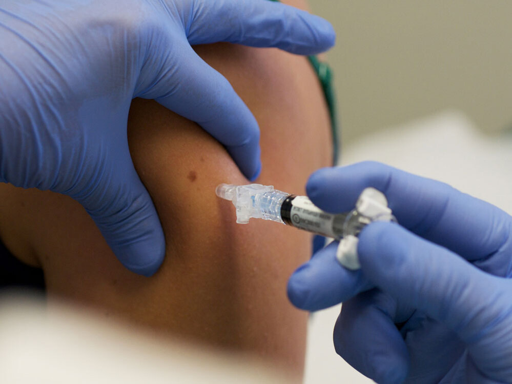 A woman is given a shot of the H1N1 vaccine.