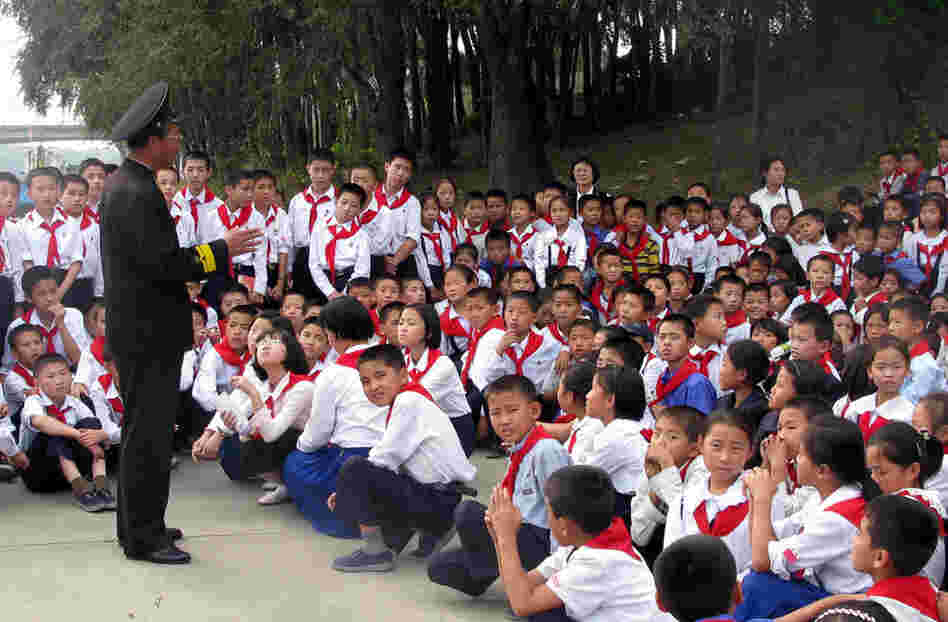 Schoolchildren listen to a lecture by one of the first North Koreans to board the USS Pueblo
