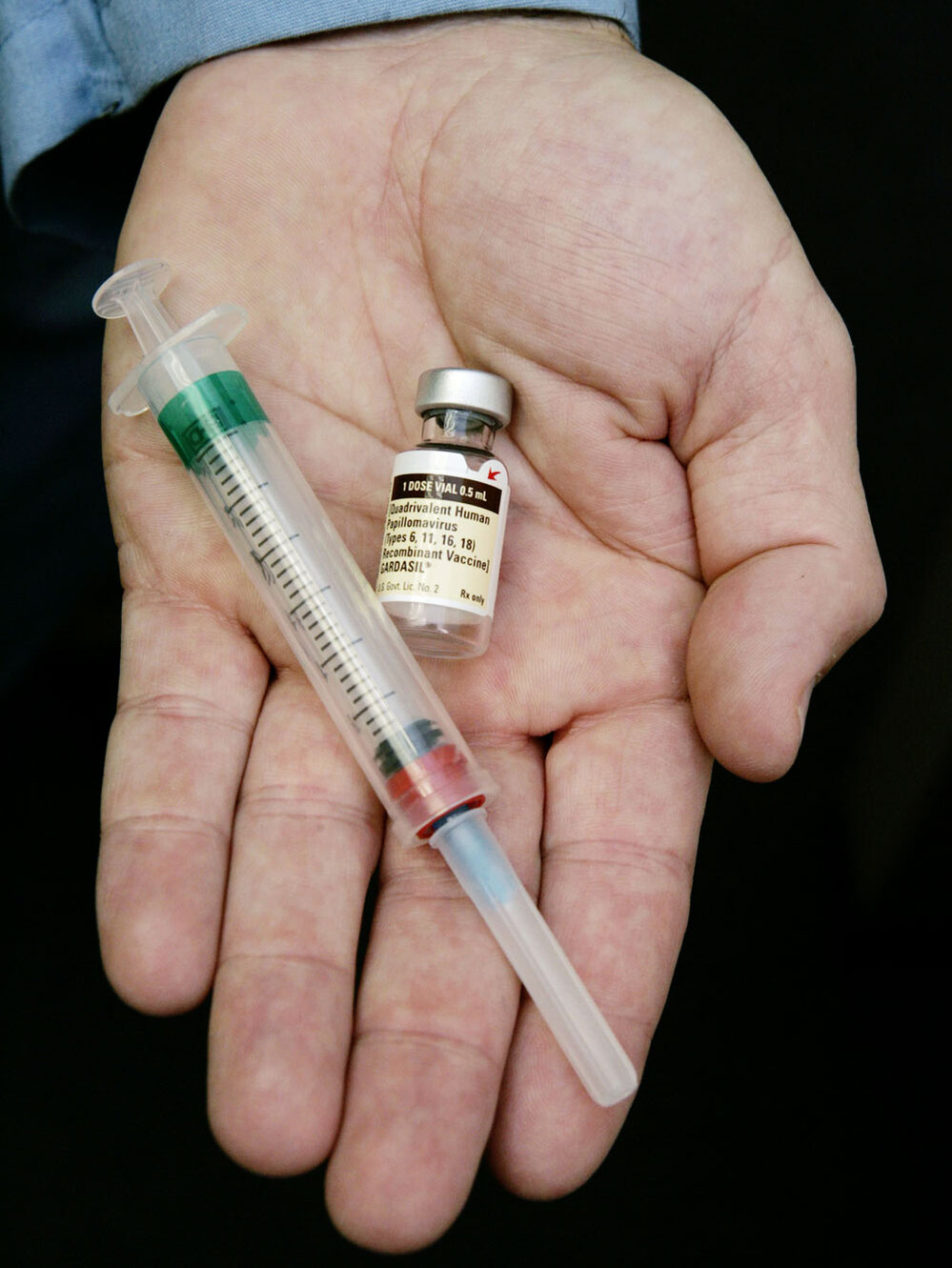 A doctor holds the human papilloma virus vaccine Gardasil.