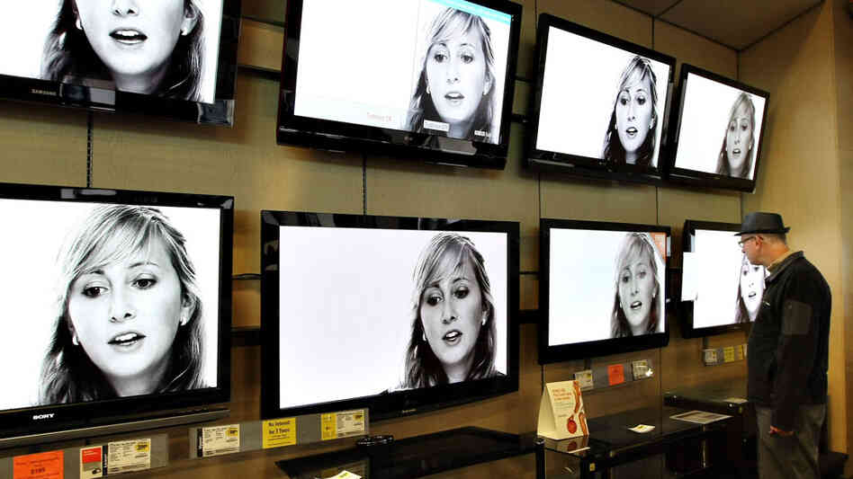 Wide: A customer looking at flat-panel televisions Wide: A customer looking at flat-panel televisions