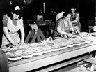 Women pack bullets into machine gun belts during World War II. Women pack bullets into machine gun belts during World War II.