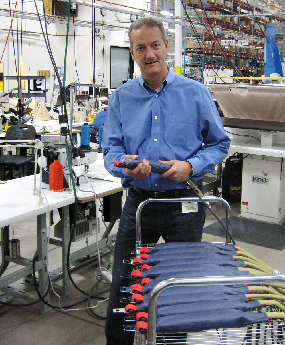 CUSTOM: AmSafe's Bill Hagan displays the seatbelts with air bags