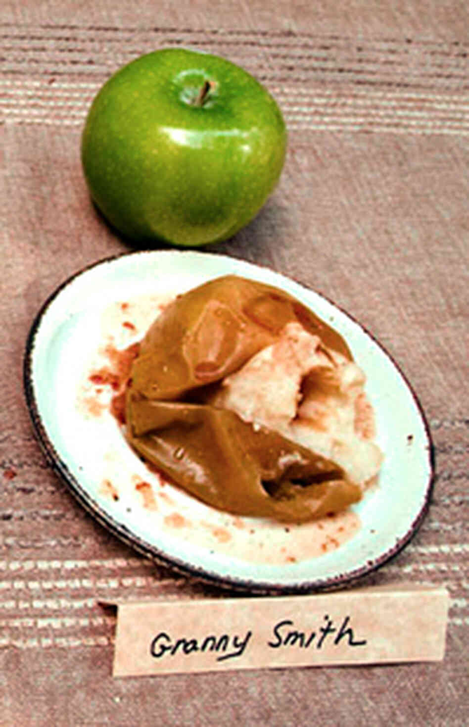 Two Granny Smith apples -- one baked and one fresh Two Granny Smith apples -- one baked and one fresh