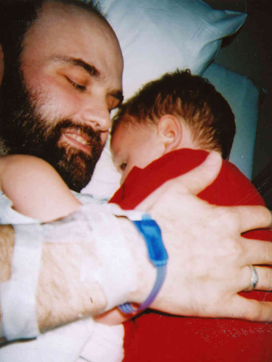 Fred Holliday holds his son Issac.