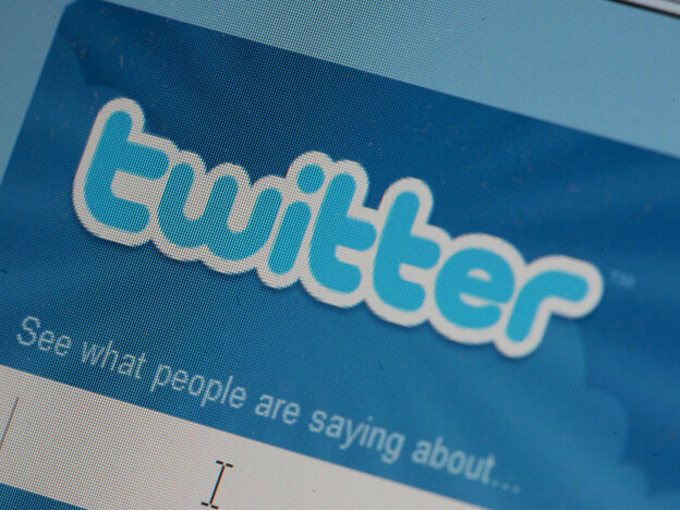 The Twitter icon, displayed on a laptop