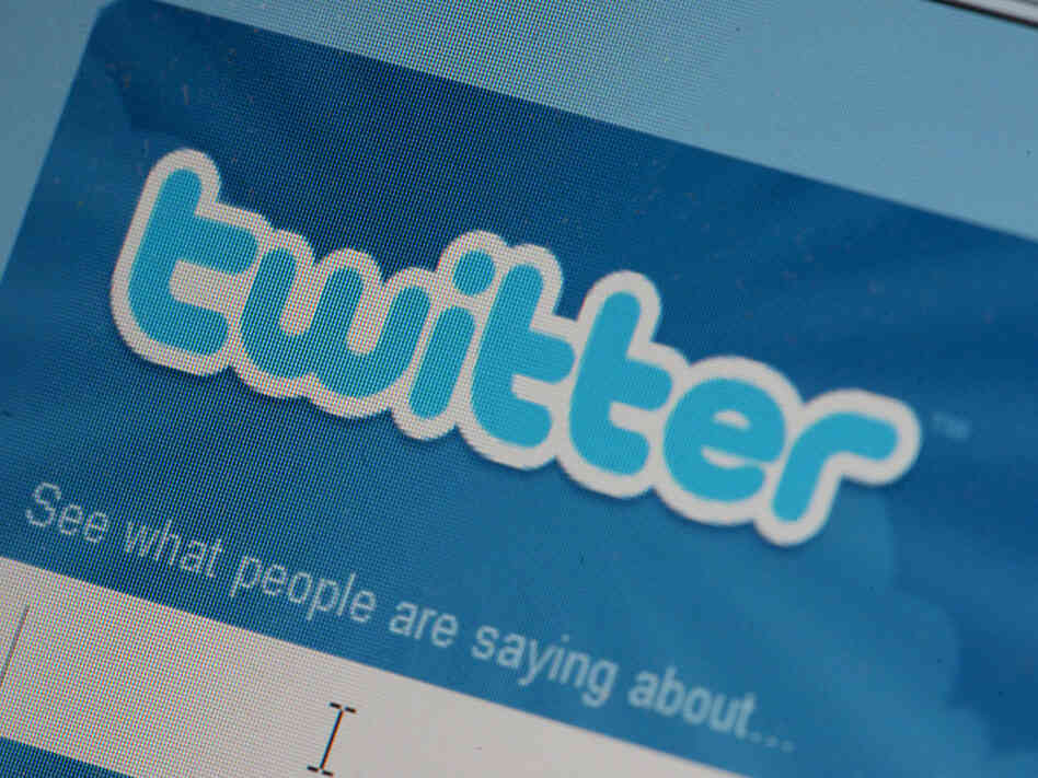 The Twitter icon, displayed on a laptop