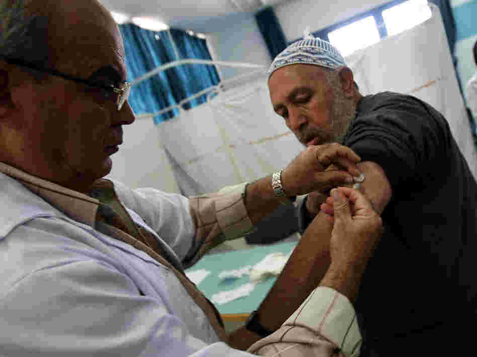 A Palestinian man who has registered to make the hajj gets a flu shot in Gaza City