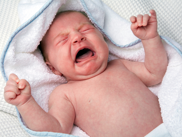 A newborn baby cries.