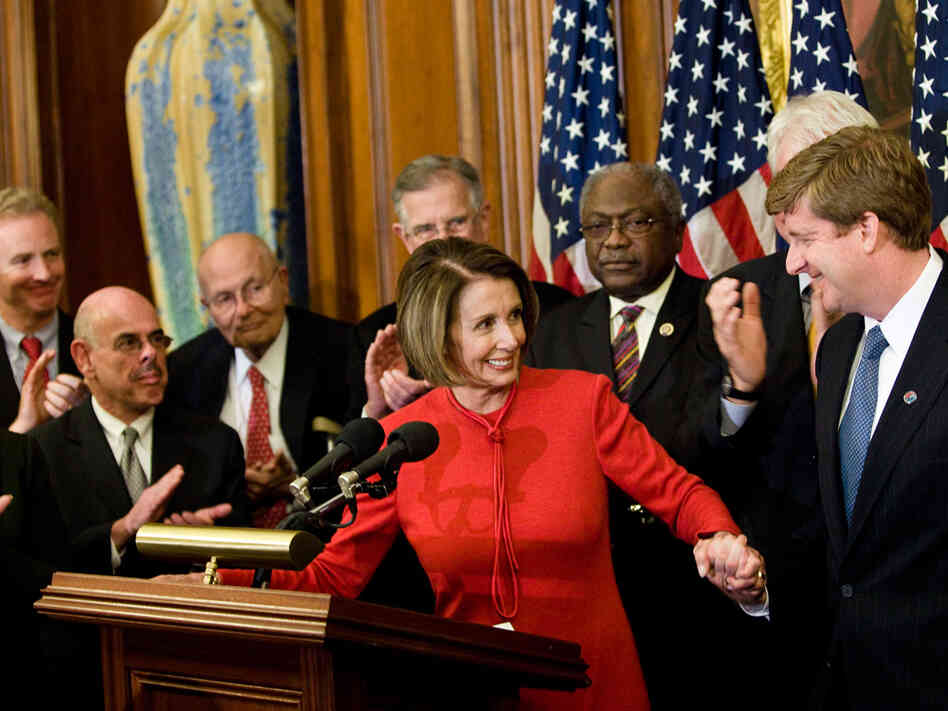 House Speaker Nancy Pelosi takes the hand of Rep. Patrick Kennedy. Brendan Smialowski/Getty Images