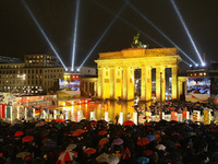 Spectators watch as giant, painted dominoes stand along the route of the former Berlin Wall near the Brandenburg Gate on Monday in Berlin. The approximately 1,000 dominoes, painted by schoolchildren and artists all over the world, are meant to symbolically represent the end of communist rule across Eastern Europe and are the highlight of celebrations in the German capital marking the 20th anniversary of the fall of the Berlin Wall.