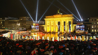 Spectators watch as giant, painted dominoes stand along the route of the former Berlin Wall near the Brandenburg Gate on Monday in Berlin. The approximately 1,000 dominoes, painted by schoolchildren and artists all over the world, are meant to symbolically represent the end of communist rule across Eastern Europe and are the highlight of celebrations in the German capital marking the 20th anniversary of the fall of the Berlin Wall.