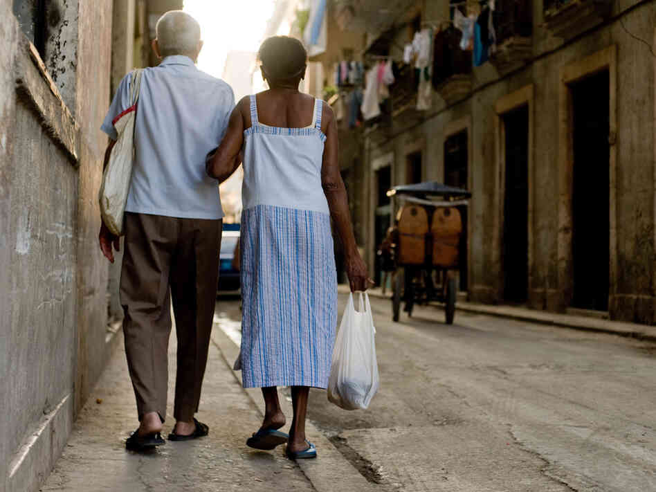 A Cuban couple returns home from a governmental food store in Havana on Wednesday.