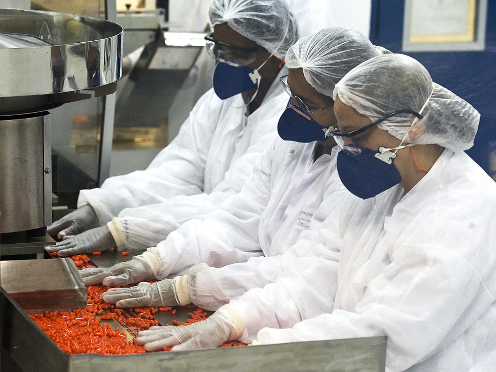 Workers at a Brazilian government  lab pack pills of Oseltamivir, similar to Tamiflu.