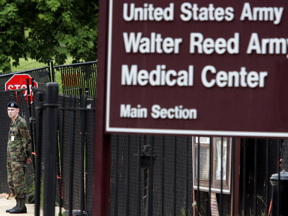 A guard stands at an exit for Walter Reed Army Medical Center.