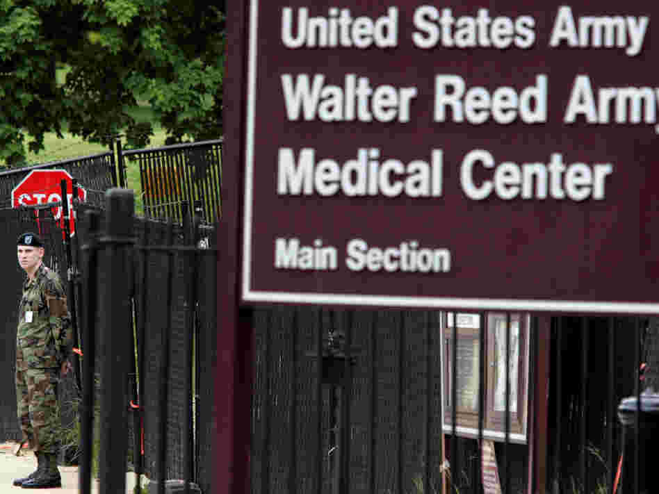A guard stands at an exit for Walter Reed Army Medical Center.