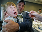 Boy pulls away after receiving H1N1 nasal spray vaccine. Boy pulls away after receiving H1N1 nasal spray vaccine.