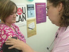A nurse examines a patient in Kentucky. A nurse examines a patient in Kentucky.