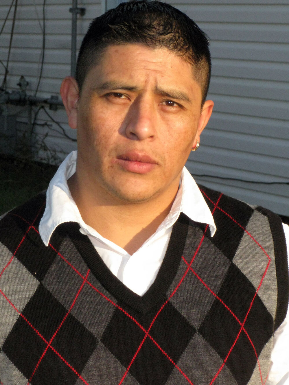 Joselo Lucero stands at the site where his brother, Marcelo, died one year after his murder.