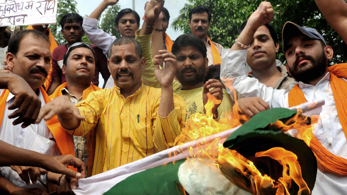 Indian protesters burn a Pakistani national flag