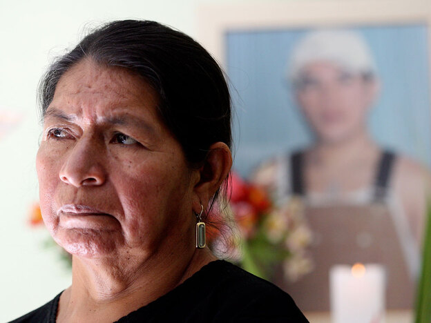 Rosario Lucero poses at her home by a small memorial for her son, Marcelo, in Gualaceo, Ecuador.