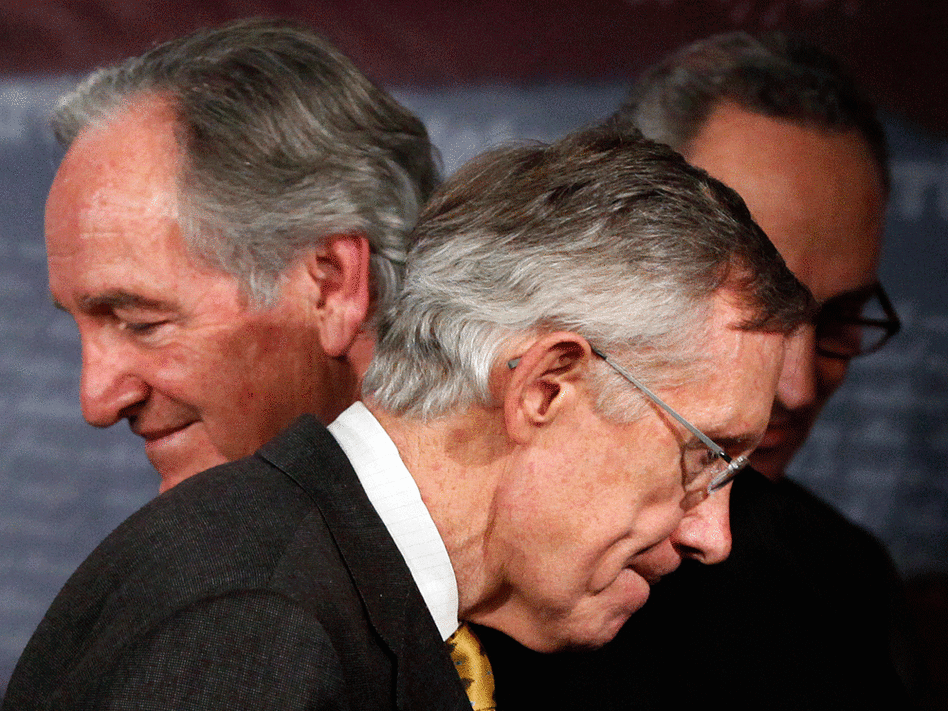 Majority Leader Harry Reid flanked by Sens. Tom Harkin (left) and Charles Schumer