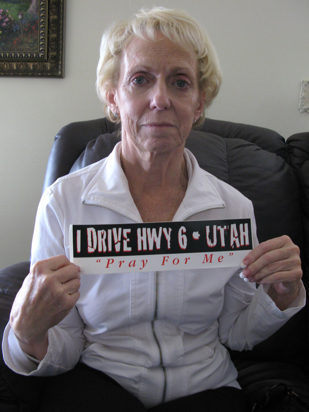 Kathy Justice with a bumper sticker that says I Drive Hwy 6 - Utah Pray For Me