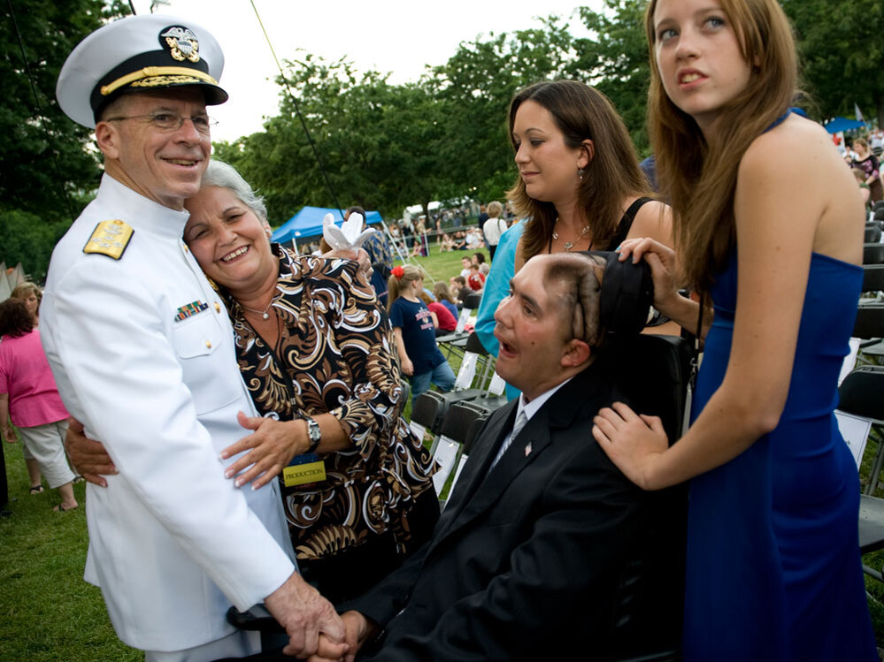 Navy Adm. Mike Mullen, chairman of the Joint Chiefs of Staff, is embraced by Nellie Bagley.