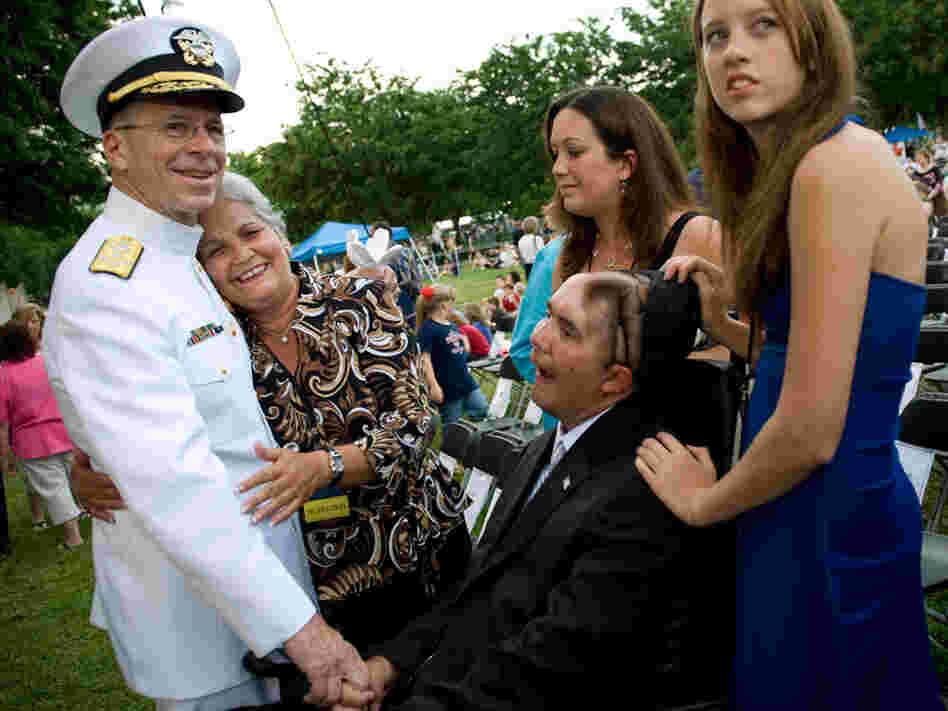 Navy Adm. Mike Mullen, chairman of the Joint Chiefs of Staff, is embraced by Nellie Bagley.