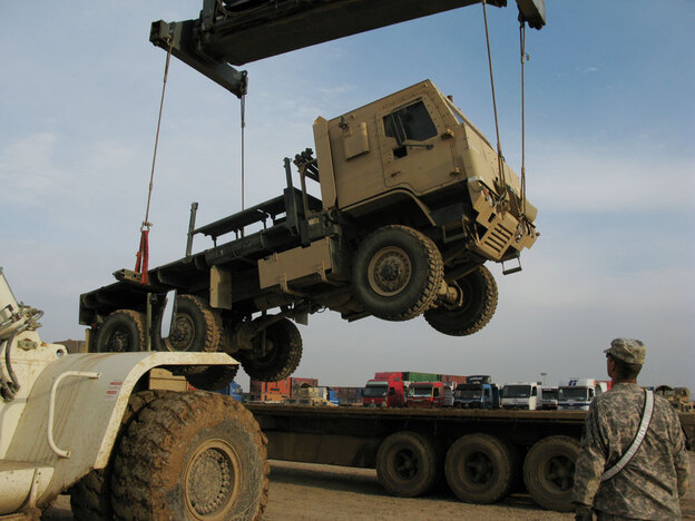 Armored transport truck loaded onto a flatbed in Balad, Iraq