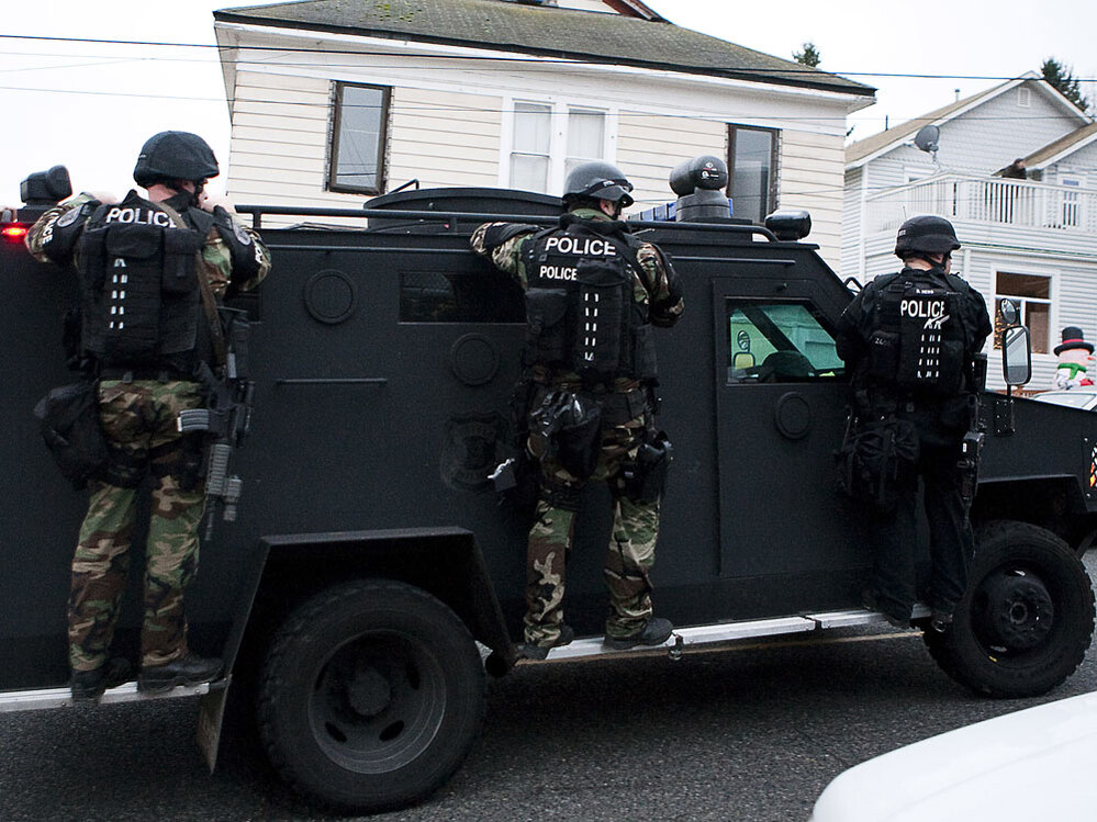 A Seattle police SWAT vehicle leaves the scene of a search for Maurice Clemmons.